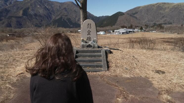 サティアン跡地に立つ慰霊碑に向かう加奈さん（画像提供／NHK）